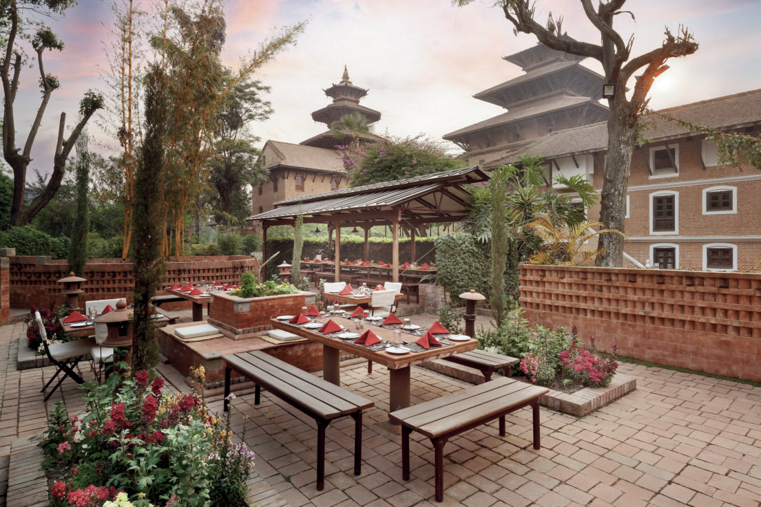 Patan Museum Café heritage courtyard with dining tables and gardens